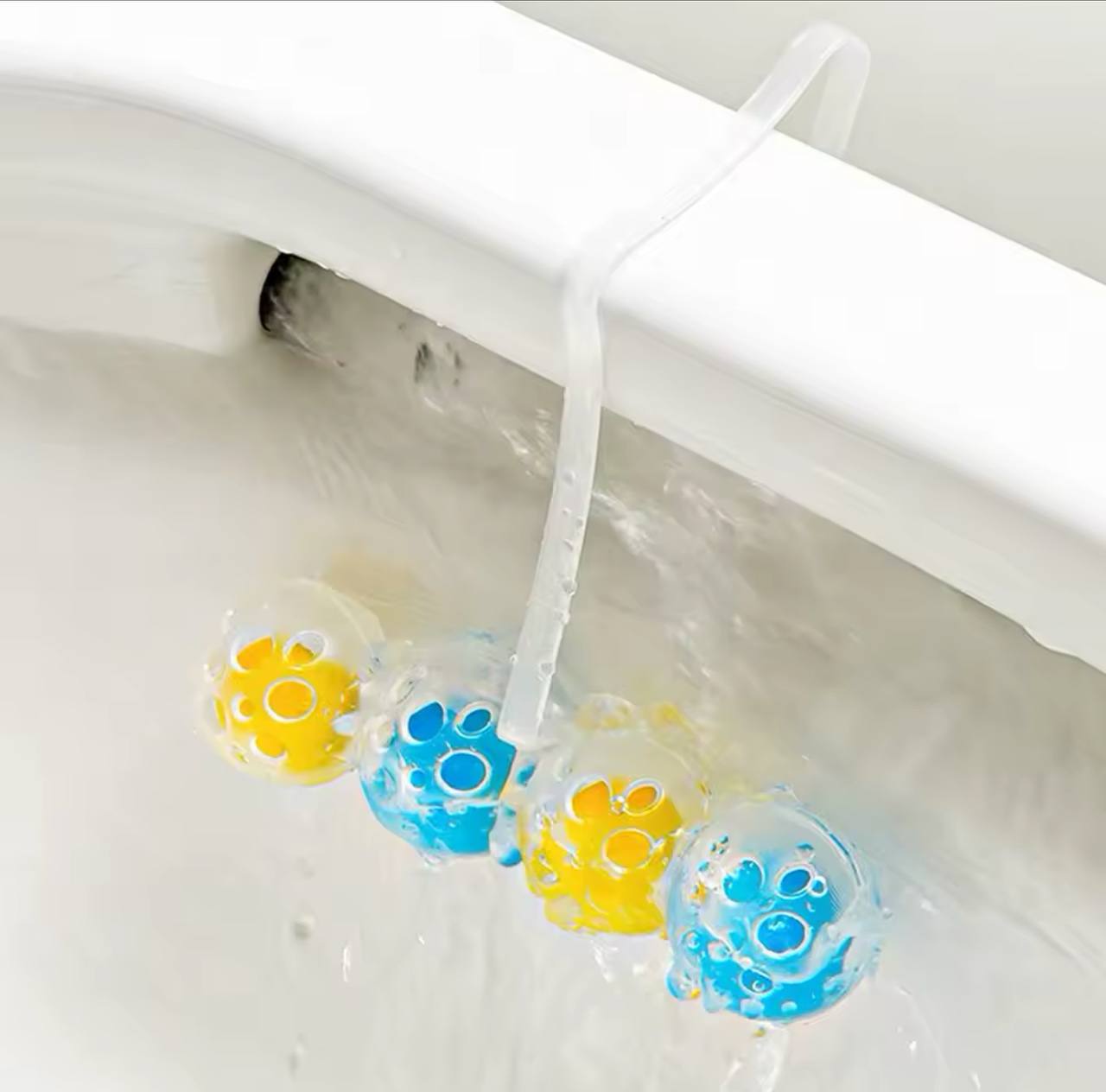 Suspended toilet cleaning ball